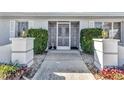 Inviting front entrance with security door, manicured hedges, and decorative lanterns at 977 N Doral Ln, Venice, FL 34293