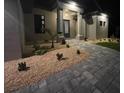 Well-lit front entrance showcasing a walkway and desert-style rock garden at 13831 Begonia Cir, Port Charlotte, FL 33981