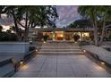 Inviting outdoor space featuring a patio and lush landscaping with tropical plants at 1648 Shelburne Ln, Sarasota, FL 34231
