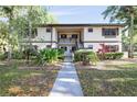 Charming two-story condo with well-maintained landscaping and inviting walkway at 19505 Quesada Ave # B202, Port Charlotte, FL 33948