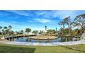 Picturesque water view showcases a community island with docks, lush landscaping, and serene waterfront living at 202 South Dr, Englewood, FL 34223