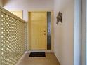 A yellow front door and lattice fence welcome guests in this nicely decorated and maintained home at 220 Southampton Drive # 325, Venice, FL 34293