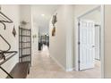 Bright hallway with tile flooring and decorative wall accents leads to the main living area at 2572 Sherman Oak Dr, North Port, FL 34289