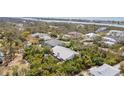 Stunning aerial view of a home nestled amongst lush greenery with waterfront views in the distance at 2760 Lemon Ave, Englewood, FL 34223