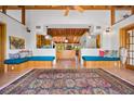 Open living space with vaulted ceilings, custom built-in benches, and a large area rug at 2760 Lemon Ave, Englewood, FL 34223