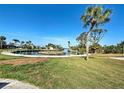 An expansive backyard with waterfront views, palm trees, and lush green lawn at 408 S Mccall Rd, Englewood, FL 34223