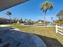 A backyard view featuring mature palm trees overlooking the waterfront at 408 S Mccall Rd, Englewood, FL 34223