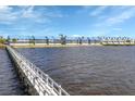 Waterfront condos with long dock over water, lush green grass, and beautiful blue roofs at 4410 Warren Ave # 217, Port Charlotte, FL 33953