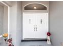 Elegant double front doors with decorative details and a welcoming entrance space at 52 Mariner Ln, Rotonda West, FL 33947