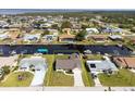 An aerial view reveals a well-maintained home with a spacious yard and easy canal access at 5266 Cooper Ter, Port Charlotte, FL 33981