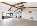 A spacious living room features exposed beams, ceiling fans, and neutral tiling at 5266 Cooper Ter, Port Charlotte, FL 33981