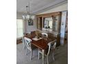 Traditional dining room with wooden table, chairs, buffet, and chandelier, ideal for gatherings at 6162 Redwing Ave, Englewood, FL 34224