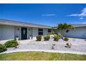 Welcoming home with attractive landscaping, a tidy yard, and a recently-painted exterior for great curb appeal at 62 Oakland Hills Pl, Rotonda West, FL 33947