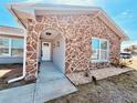 Stunning stone-accented front entrance with arched doorway and well-kept landscaping at 6375 Coniston St, Port Charlotte, FL 33981