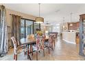 Elegant dining room with stylish chandelier, patio access, and views of the golf course at 758 Rotonda Cir, Rotonda West, FL 33947