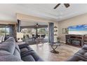 Inviting living room with tile flooring, a tray ceiling, and a seamless flow to outdoor living at 758 Rotonda Cir, Rotonda West, FL 33947