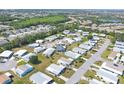 High aerial view of a Florida retirement community boasting cozy mobile homes and lush landscapes at 816 Tangerine Woods Blvd, Englewood, FL 34223
