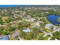 Aerial view of a home nestled in a lush, green neighborhood, near a lake at 850 Van Gogh Road, Englewood, FL 34223