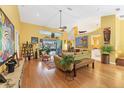 A bright living area with a fan, wood floors, and plants galore at 850 Van Gogh Road, Englewood, FL 34223