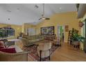 Spacious living room featuring vaulted ceilings, eye-catching wall art, and comfortable seating at 850 Van Gogh Road, Englewood, FL 34223