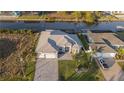 Aerial view of a beautiful waterfront home with a private dock and lush landscaping at 9214 Melody Cir, Port Charlotte, FL 33981