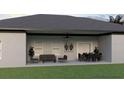 Well-appointed outdoor living space with comfortable seating and a dining area under a ceiling fan at Lot 11Blk 100 7Th Oracle Ln, North Port, FL 34286