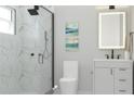 Modern bathroom featuring a glass-enclosed shower with marble walls and a sleek vanity at Lot 18Blk 257 7Th Alabelle Ln, North Port, FL 34286