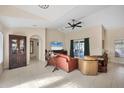 Cozy living room features high ceilings, neutral paint, and sliding glass door to the patio at 10039 Sunday Dr, Port Charlotte, FL 33981