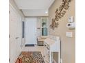Inviting entryway featuring tile floors, a stylish desk, and tasteful decor at 10055 Links Ln # 402, Rotonda West, FL 33947