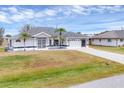 Well-maintained single-Gathering home featuring an attached two-car garage and a landscaped front yard at 10060 Amelia Ave, Englewood, FL 34224