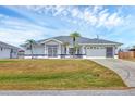 Charming single-Gathering home featuring a two-car garage and a well-maintained lawn at 10060 Amelia Ave, Englewood, FL 34224