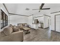 The living room features neutral walls, gray floors, a ceiling fan and furniture set at 11 Quails Run Blvd # 9, Englewood, FL 34223