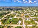 Wide aerial shot showing a residential community, streets, and green spaces from above at 115 Australian Dr, Rotonda West, FL 33947