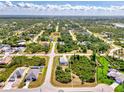 Expansive aerial view of a residential area showcasing neighborhood layout and lush greenery at 115 Australian Dr, Rotonda West, FL 33947