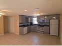 Bright kitchen featuring gray cabinets, granite countertops, and stainless steel appliances at 1160 Sharlo Cir, Englewood, FL 34224