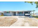 Charming single-story home with updated exterior, well-manicured lawn, and a covered carport at 140 Crestview Dr, Englewood, FL 34223