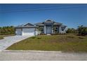 Beautiful single-story home with a well-manicured lawn and inviting entrance at 14526 Fort Worth Cir, Port Charlotte, FL 33981