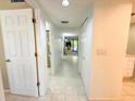 Bright hallway with tile floors and access to the living room and bathroom at 149 Englewood Isles Pkwy # 609, Englewood, FL 34223