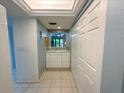 Hallway with tile floors, built in storage and a passthrough window to the lanai at 149 Englewood Isles Pkwy # 609, Englewood, FL 34223