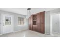View of the dining room including a door, window, and wooden built in cabinets at 150 Crestview Dr, Englewood, FL 34223