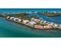An aerial view of the buildings and lush greenery surrounded by blue waterways at 1551 Beach Rd # 207, Englewood, FL 34223