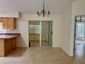 An airy dining room next to the kitchen, complete with tiled floors and a vintage chandelier at 22472 Tennyson Ave, Port Charlotte, FL 33954
