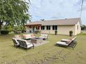 Backyard featuring an outdoor seating area and a pergola, perfect for relaxing and entertaining at 3415 Gulf Ln, Rotonda West, FL 33947