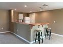 A charming kitchen area with light wood bar and cozy seating at 3415 Gulf Ln, Rotonda West, FL 33947