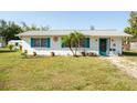 A charming single-story home boasts a well-maintained lawn and quaint curb appeal at 350 W Cowles St, Englewood, FL 34223