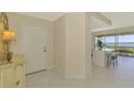 Welcoming foyer with tile floors and a peek into the open living space with water views at 4692 Club Dr # 101, Port Charlotte, FL 33953
