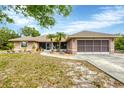 Inviting single-story home with a two-car garage and low-maintenance landscaping, complete with mature palm trees at 533 Boundary Blvd, Rotonda West, FL 33947