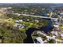 Sprawling waterfront property with lush greenery, a private dock, and easy access to the open water at 60 N Oxford Dr, Englewood, FL 34223