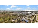 Scenic aerial view showcasing the light blue home's proximity to the water and town, perfect for coastal living at 7035 Duke St, Englewood, FL 34224