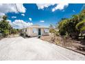 Inviting home featuring a gravel driveway and well-maintained landscaping at 7035 York St, Englewood, FL 34224